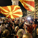 Supporters of the opposition center-right VMRO-DPMNE party celebrate in front of the party headquarters after their party announced victory in the presidential and parliamentary elections, in Skopje, North Macedonia, late Wednesday, May 8, 2024. (