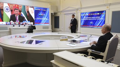 Russian President Vladimir Putin takes part in an extraordinary BRICS summit via video conference, while China's President Xi Jinping can be seen on the screen.